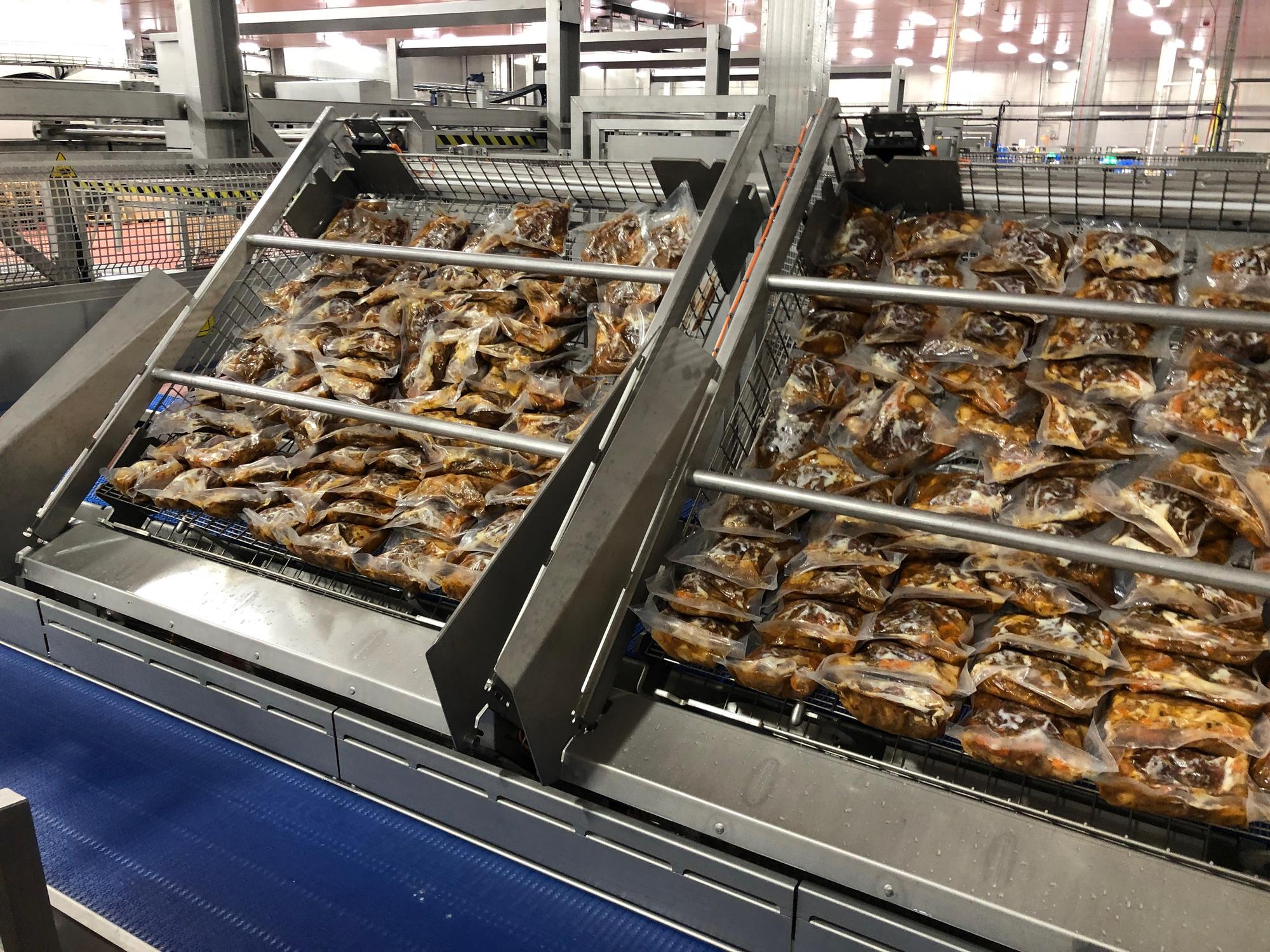 A batch of braised beef after sous-vide cook-and-chill, individually portioned and vacuum-packed on production trays